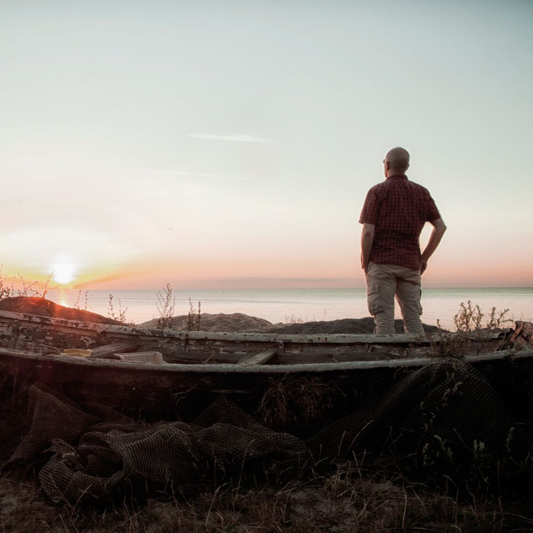 person looking out at lake