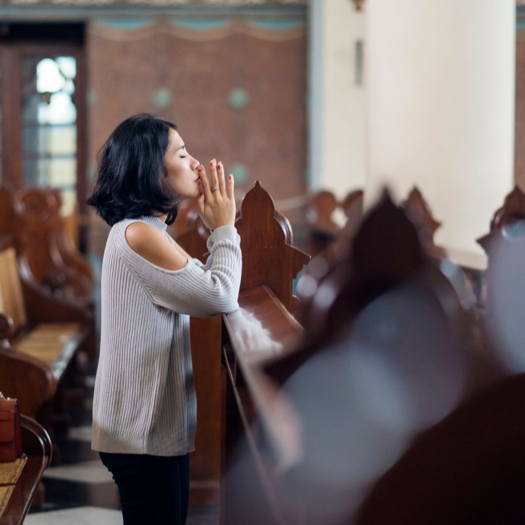 person praying in church