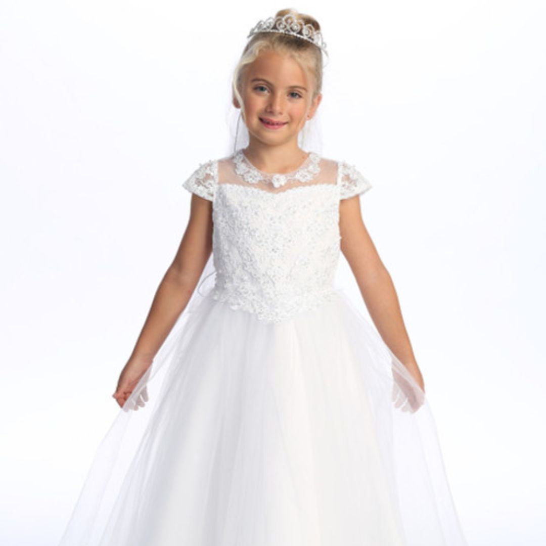 Girl in a communion dress with a tulle overlay